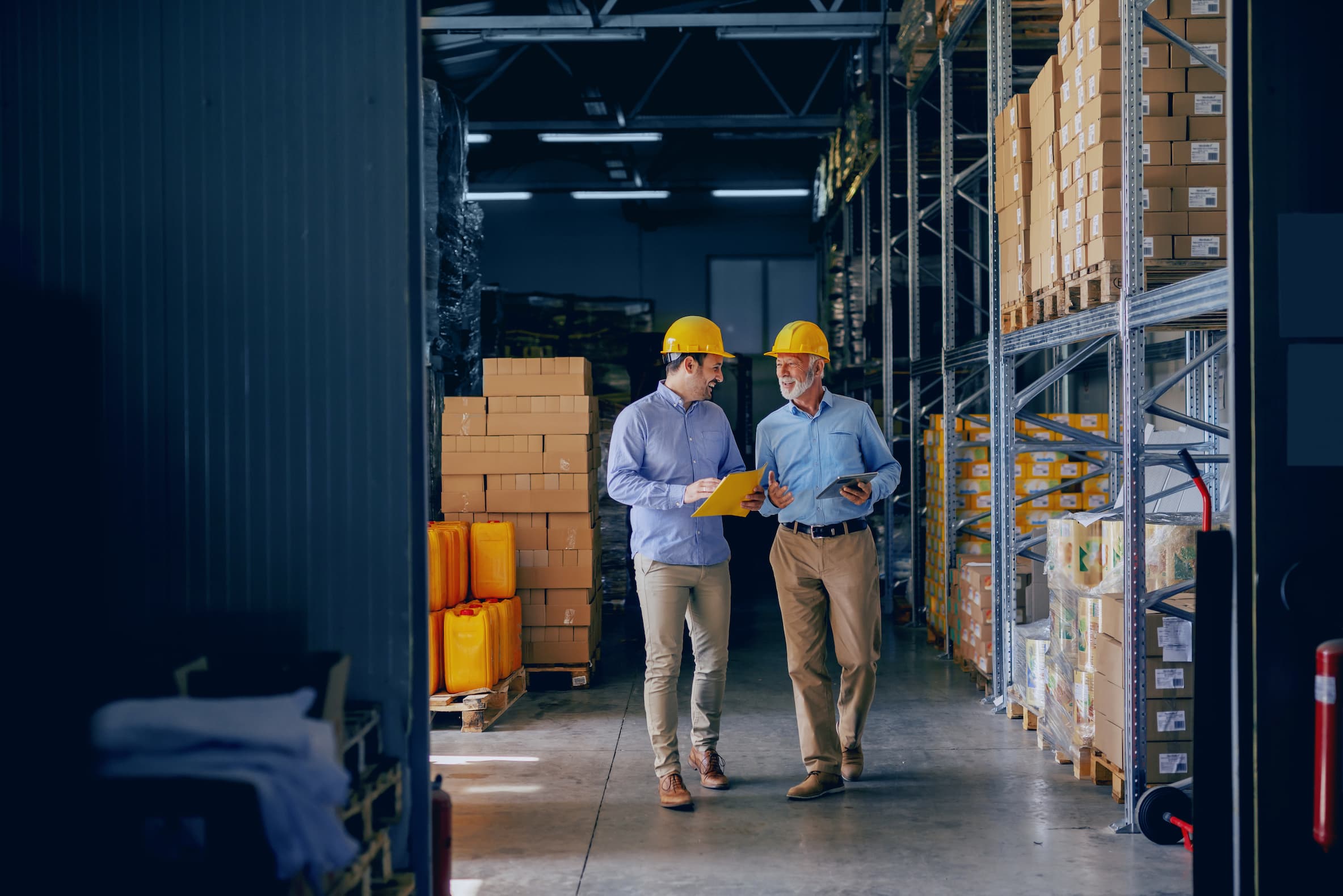 Two managers reviewing inventory in a warehouse